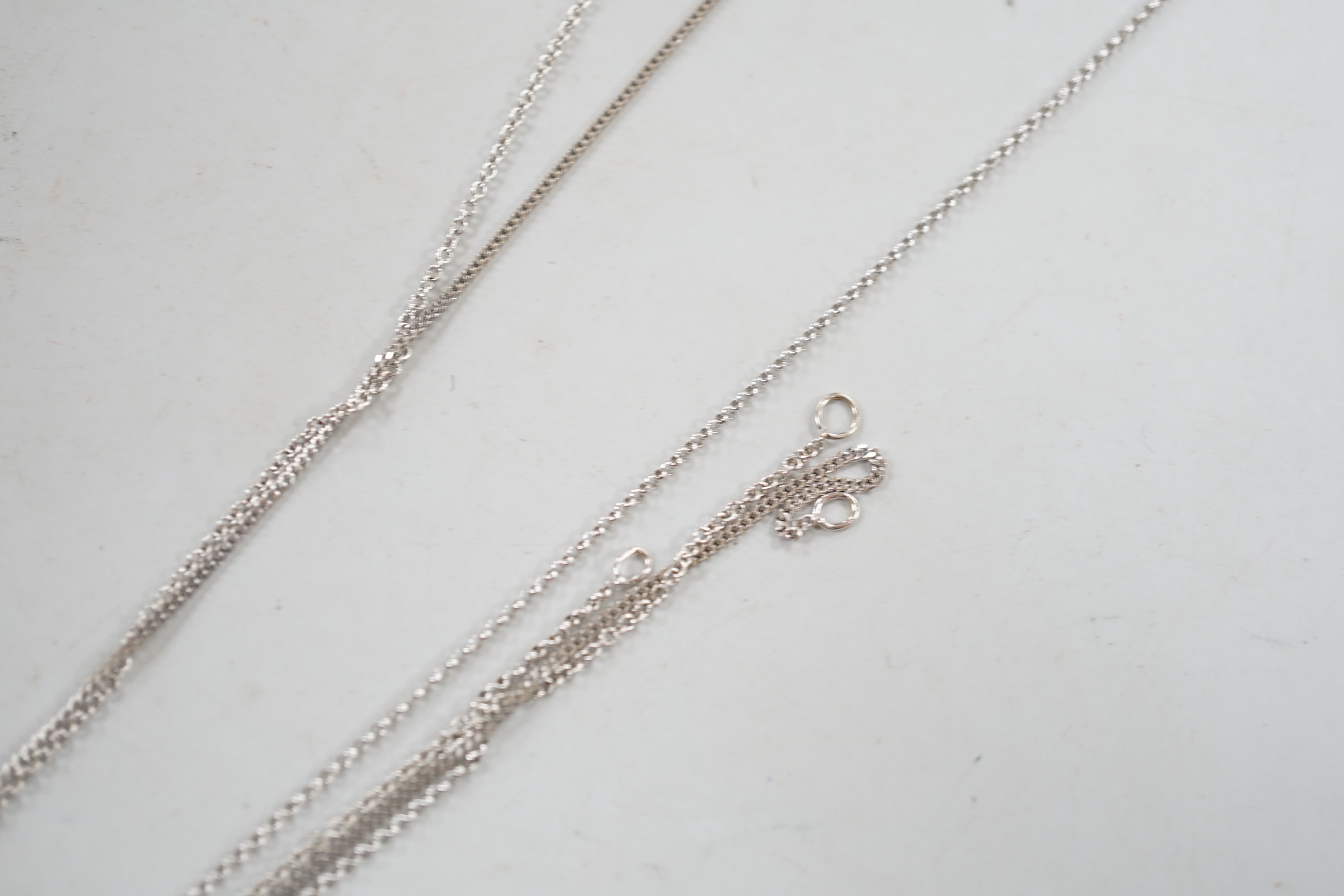 Three assorted modern 18ct white gold fine link chains, longest 42cm, 5.9 grams.